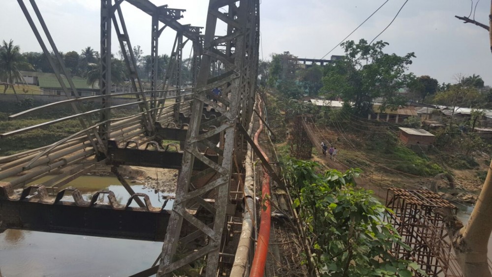 Photo caption:  People seen crossing over the Dhansiri River by walking through a temporary structure erected for other purposes beside the Old Dhansiri Bridge on March 6, 2017.  (Morung File Photo)